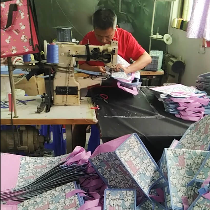 Senior sewing worker of Linway backpack manufacturer